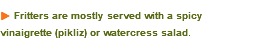 u Fritters are mostly served with a spicy vinaigrette (pikliz) or watercress salad. 